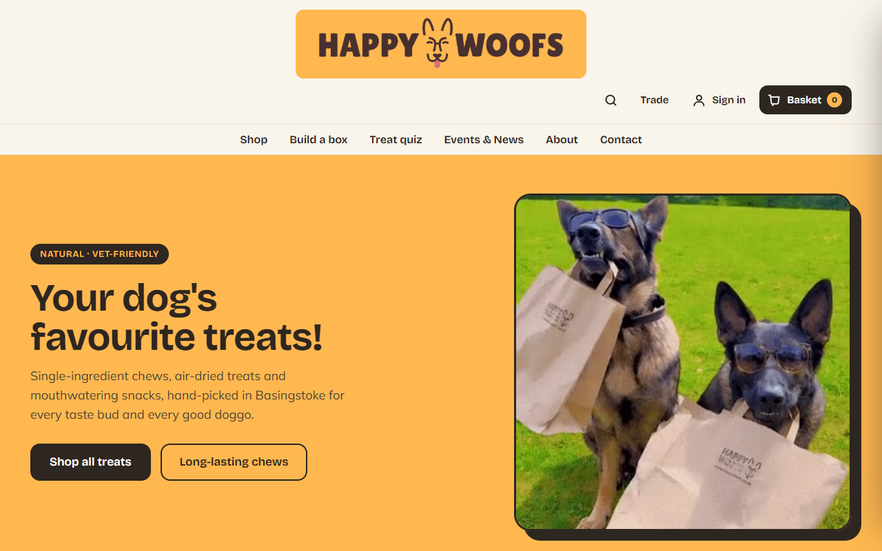 Happy Woofs homepage with Sharga mascot, natural treats hero, and warm orange brand palette